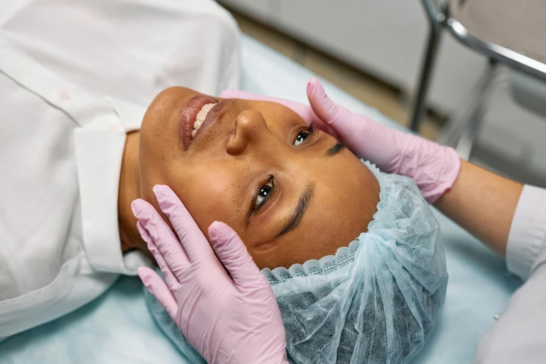 the female doctor is doing procedure on her face