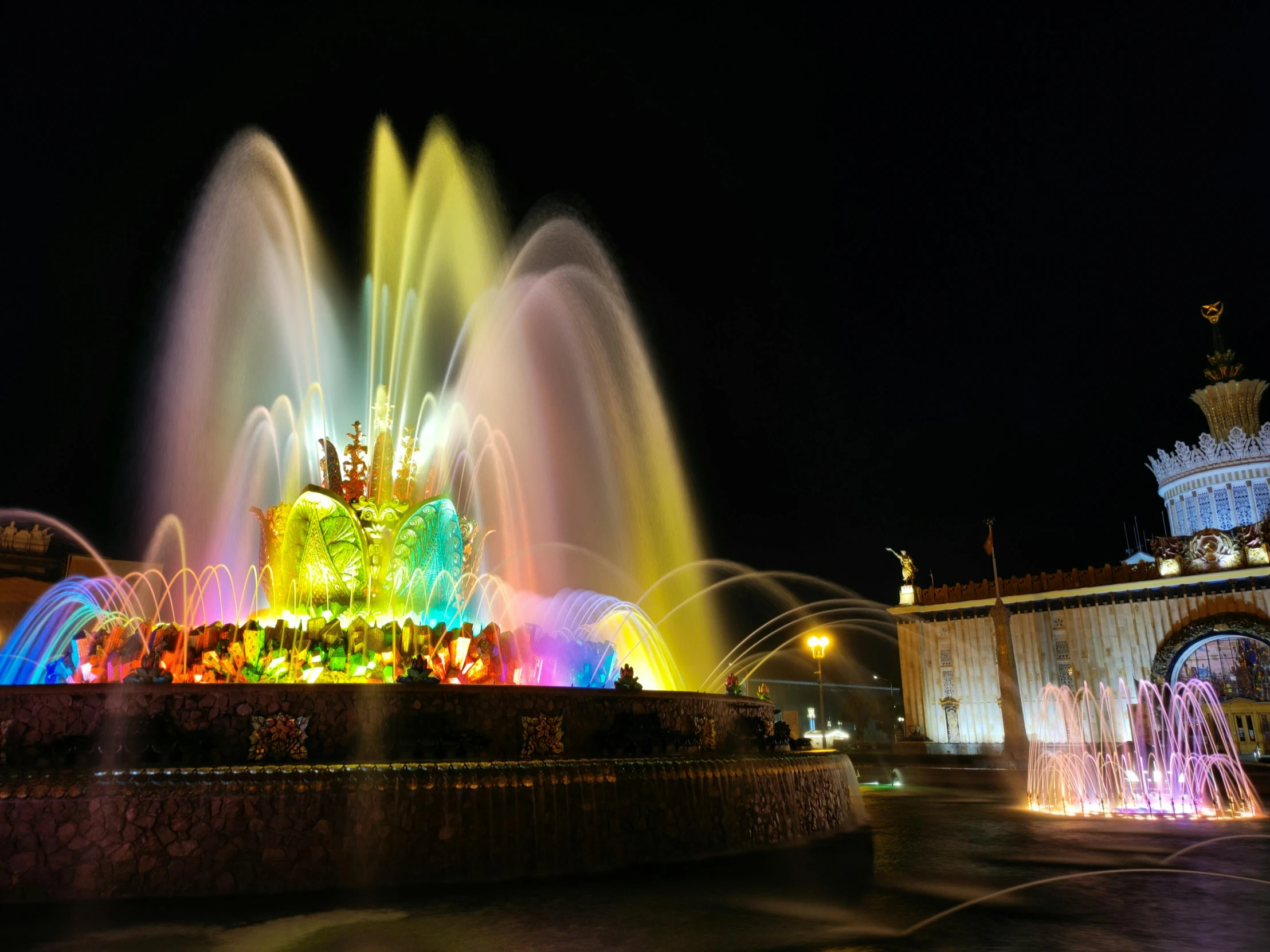 water show lit up in a large outdoor setting