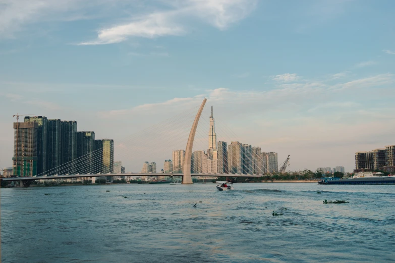 a body of water with boats in it and a bridge in the distance