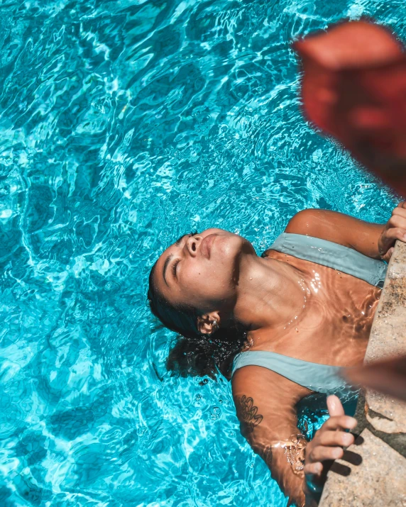 a woman is in the water smiling