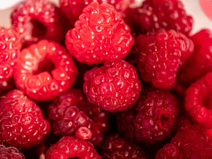 raspberries sitting on top of each other on the table