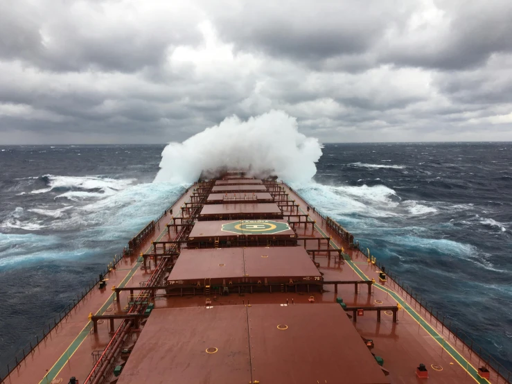 a large ship is being pulled on the water by a wave