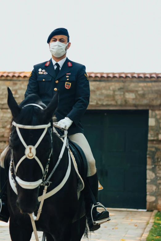 a uniformed man in uniform riding on the back of a horse