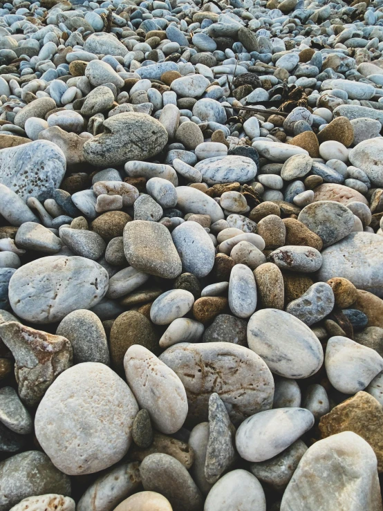 some rocks with no people on it and a gray beach