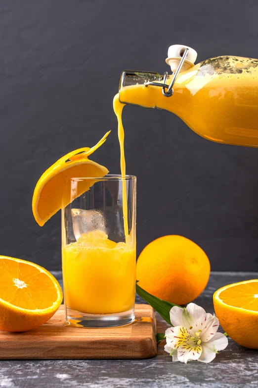 an orange juice being poured into a glass