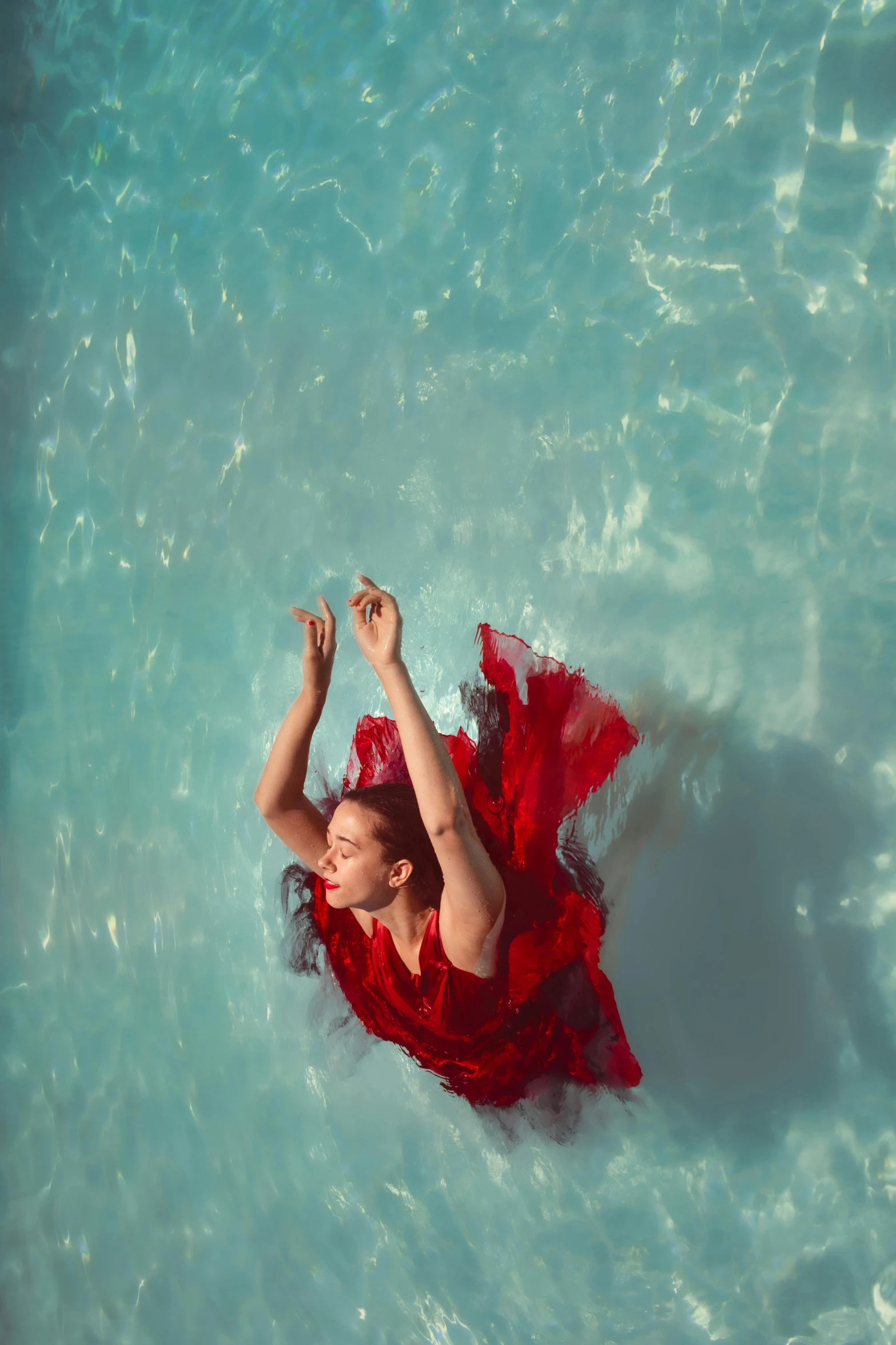 the woman in the red dress is in the water