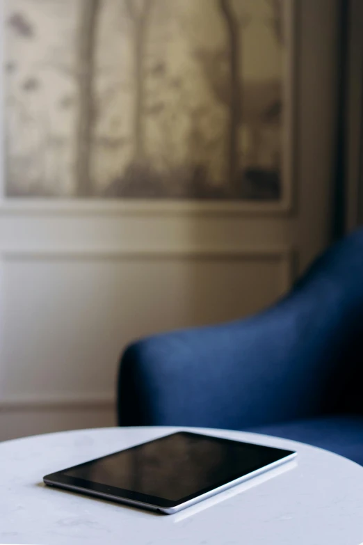 an iphone sitting on top of a white table