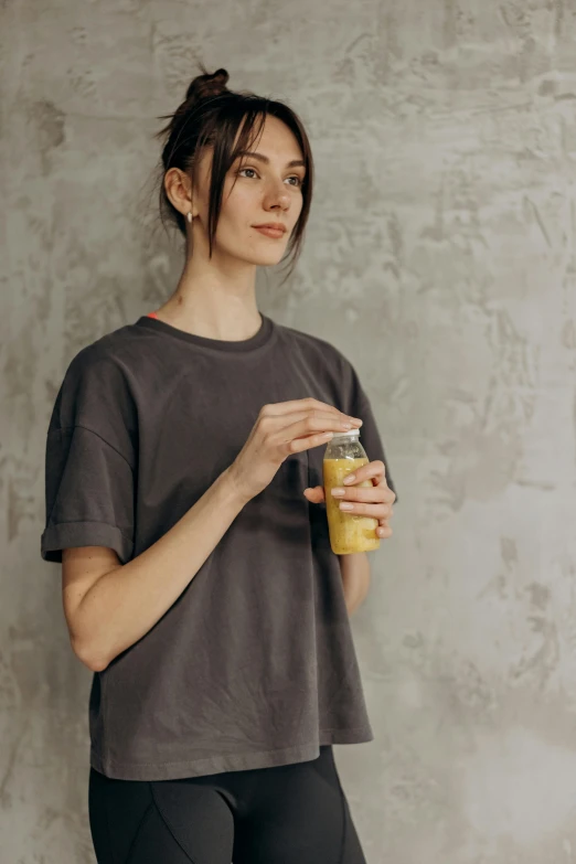 a woman standing and holding a glass