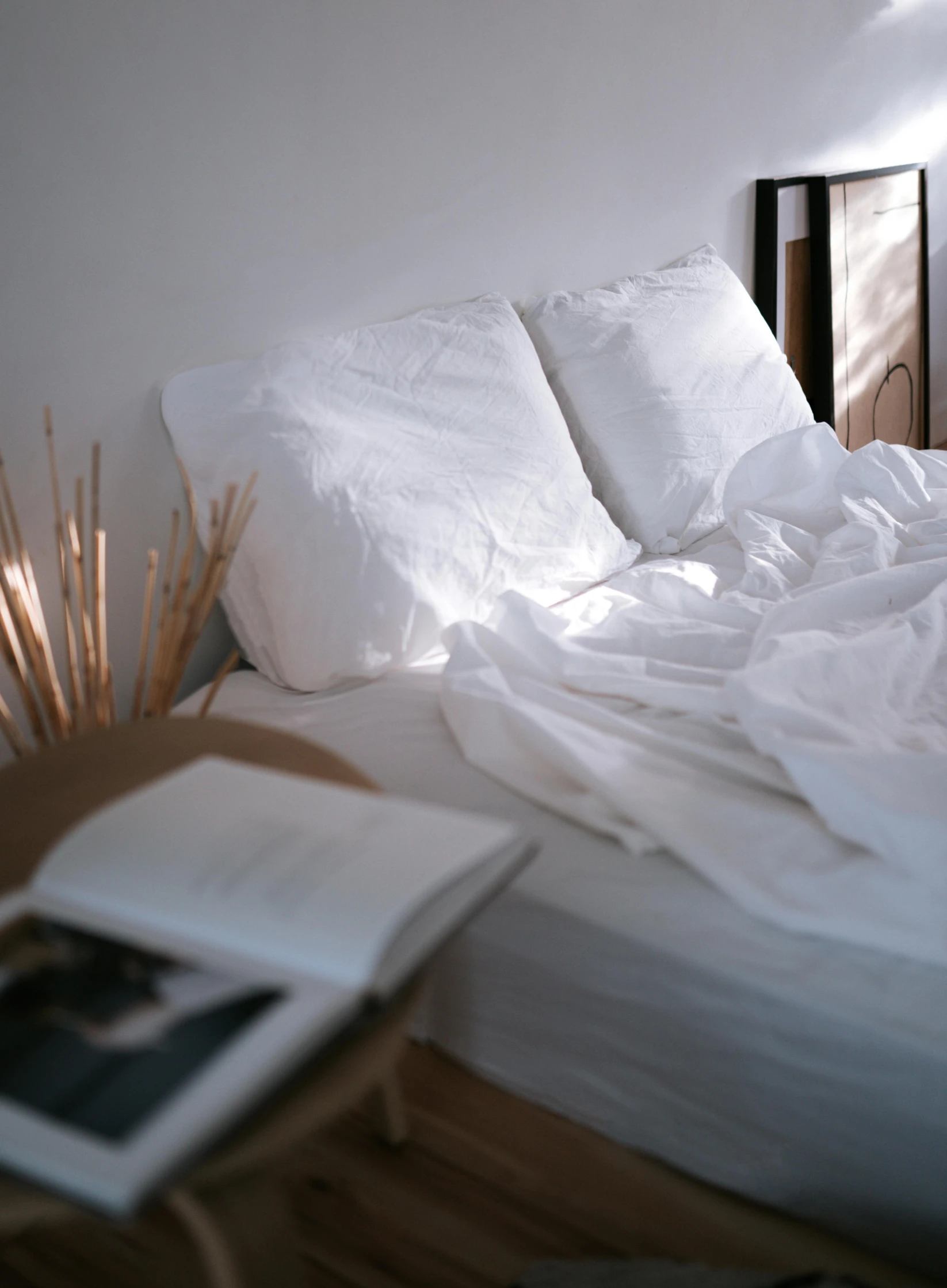 a messy bed with sheets and pillows on it