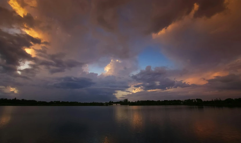 some clouds in the sky and the water