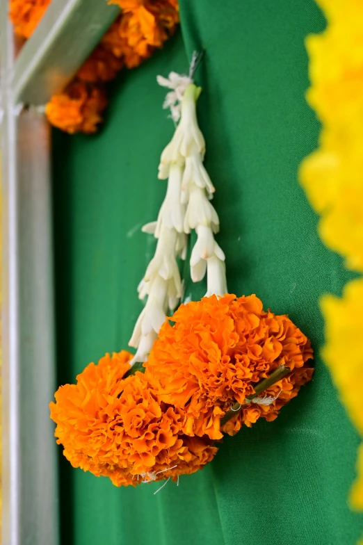 two bouquets of orange flowers on a green table