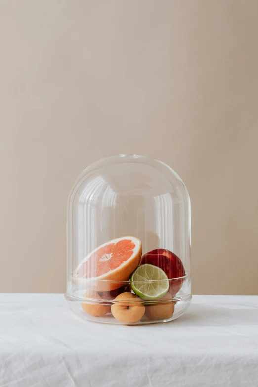 fruit is placed in a large, clear glass dome