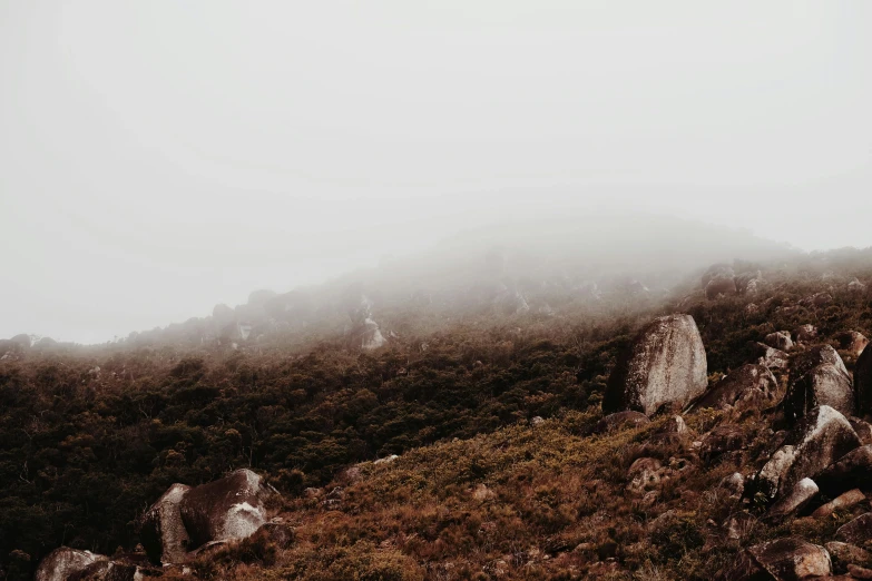 the mountain is very rocky and foggy on the top