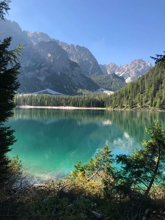 the mountains are reflected in a body of water