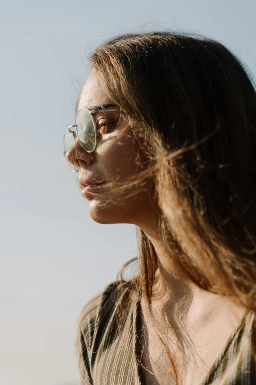 a woman wearing glasses looking away from the camera