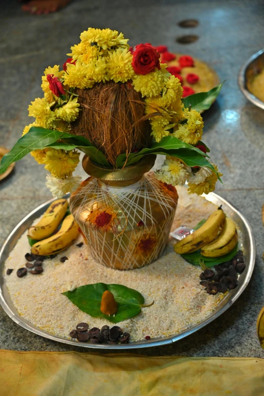 a plate topped with bananas and a vase of flowers