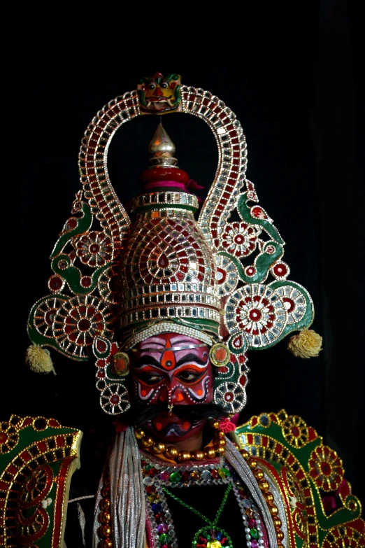 a mask and a necklace on a statue