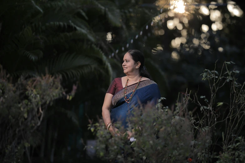 a woman sits in the shade and looks at the sky