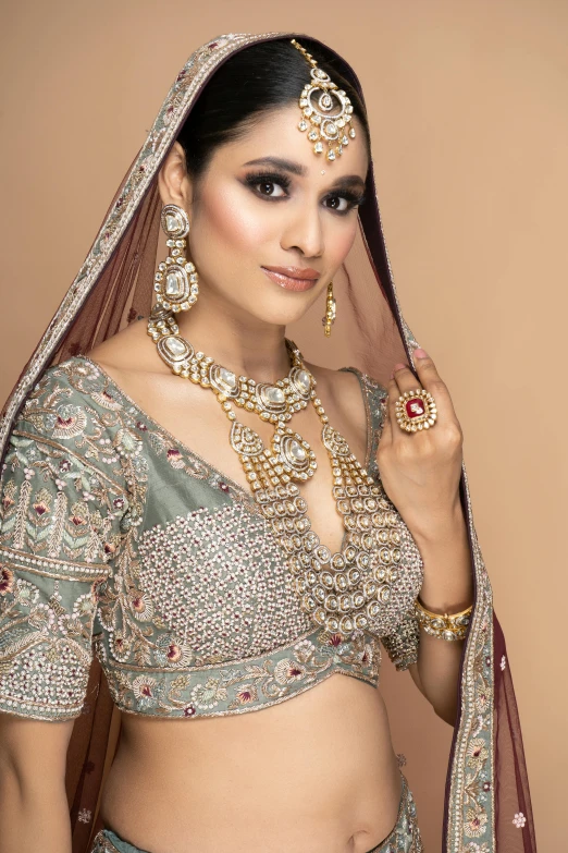 a woman wearing jewelry and jewelry from an indian fashion show