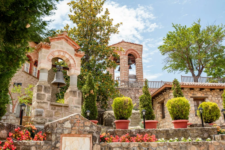 a group of buildings with flowers in front of it