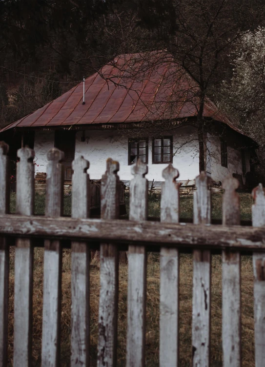 this is a picture of an old house with a fence