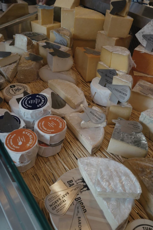 different types of cheeses on display for sale