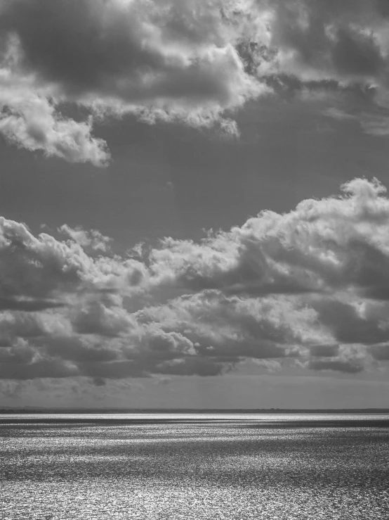 an airplane is sitting in the sky near the ocean