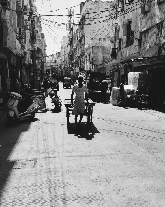 the old black and white po of people walking down a street