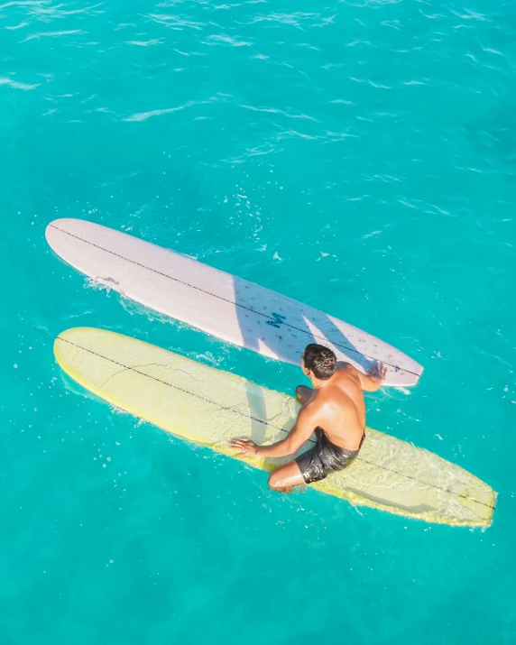 a man laying on his surfboard in the ocean