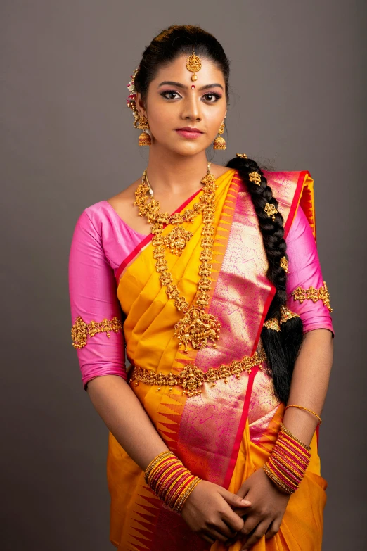 a woman in yellow and pink saree