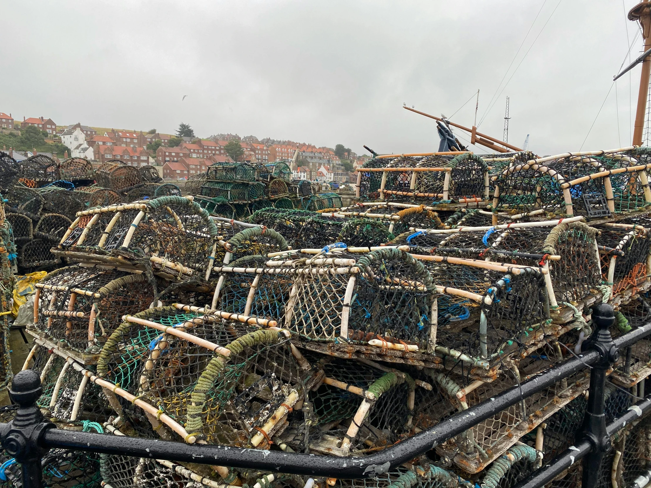 piles of fishing nets on a boat in the water