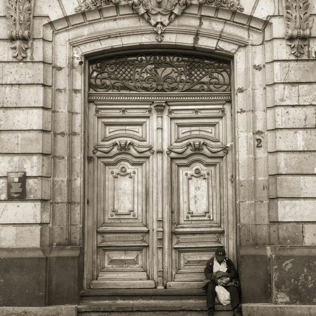 a door is open with a person seated on a bench