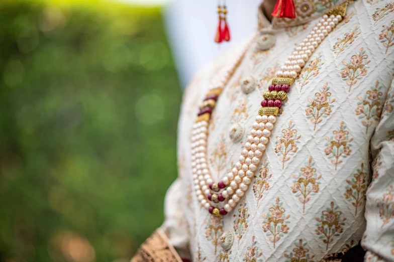 a traditional indian woman dressed in white and gold