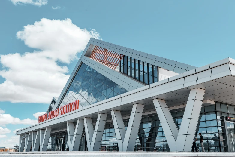 a modern building made out of white columns and a triangular roof