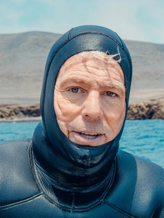 man in a wet suit by the water