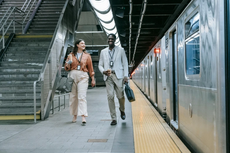 a man and woman standing on the platform of a train