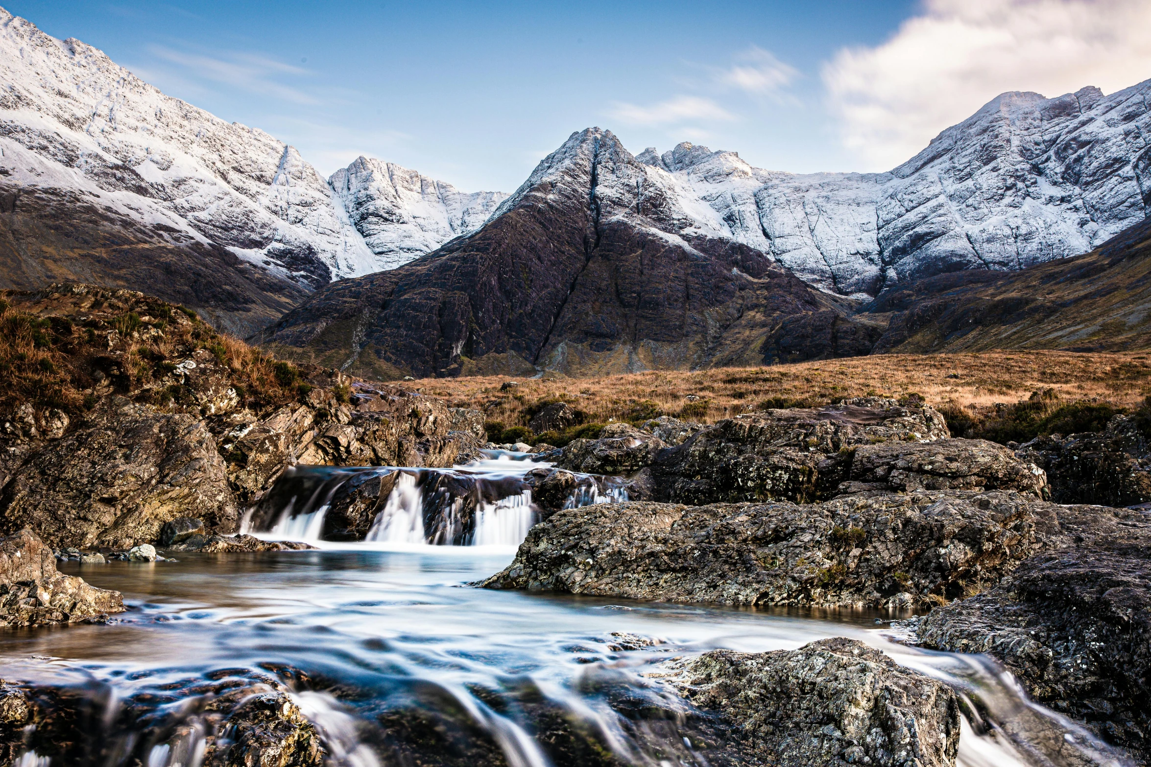 the mountain scene has been taken with a large waterfall