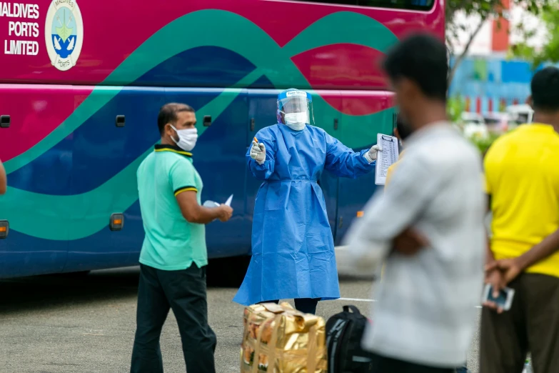 a man in medical mask walking on the sidewalk