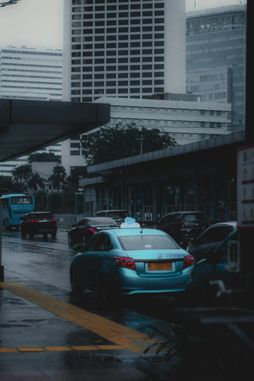 cars parked at a bus stop under a city street sign