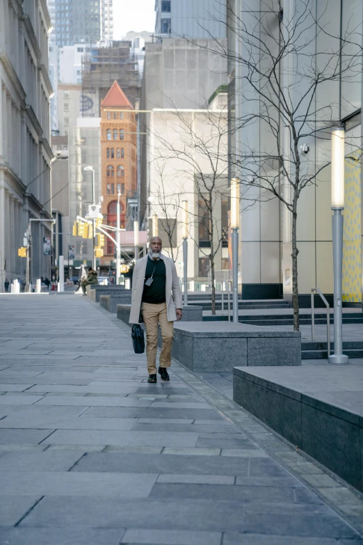 a man walking down the street in his dress shirt