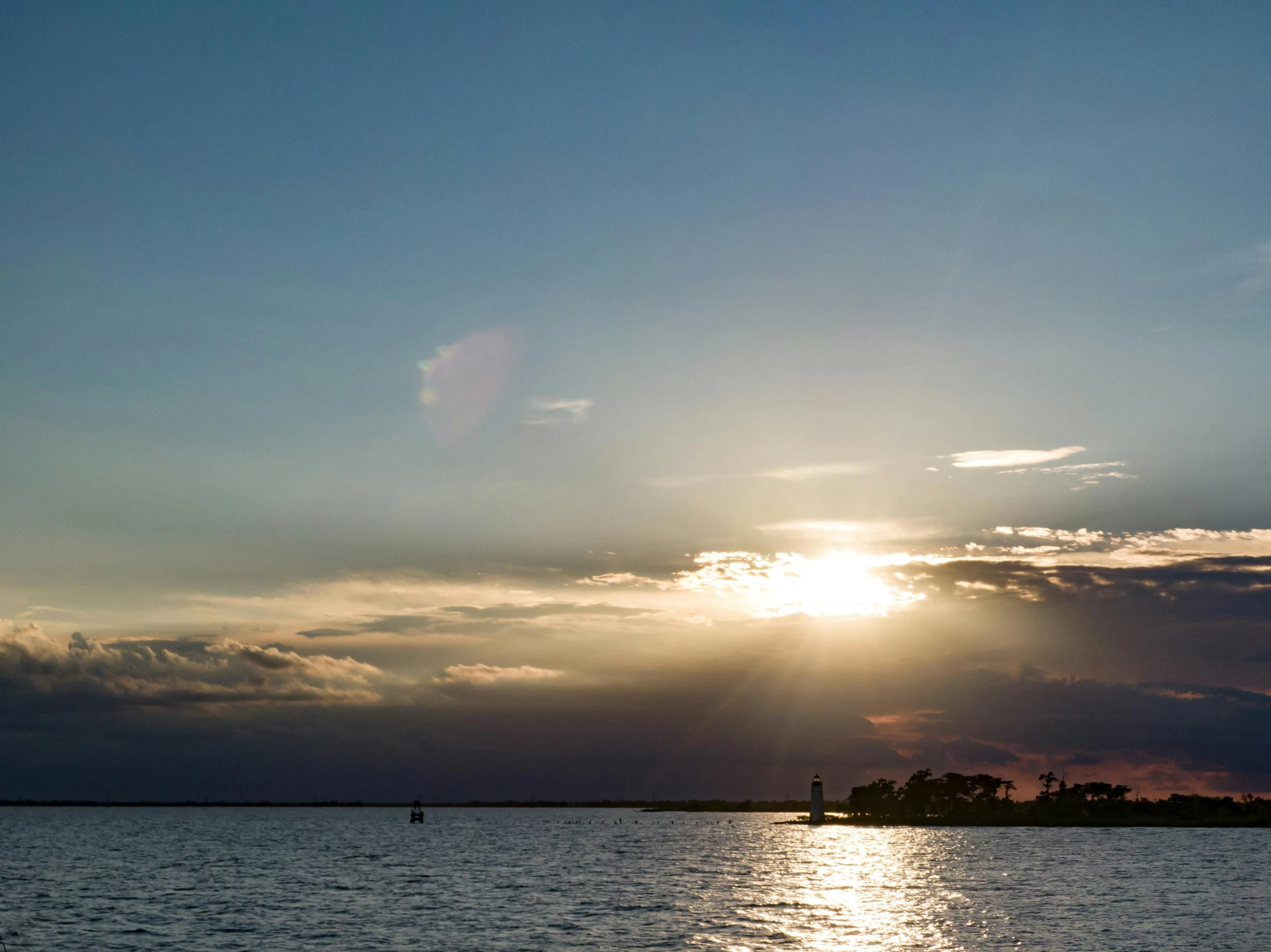 the sun shining over a large body of water