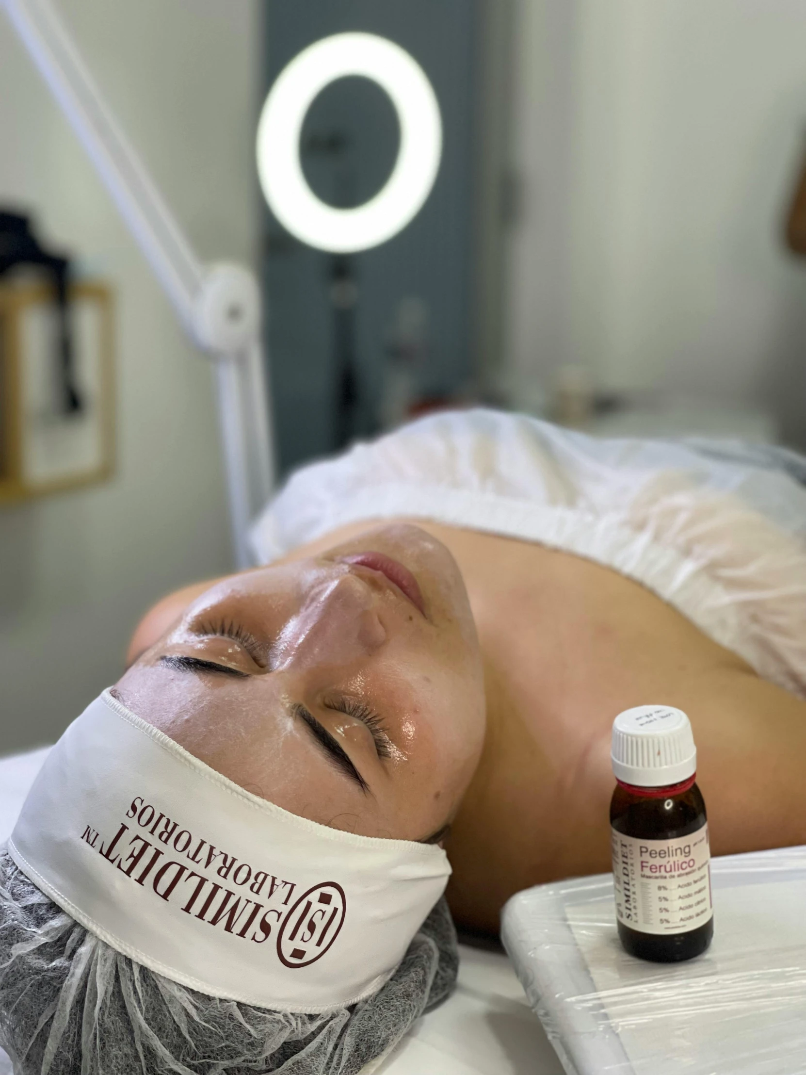 a young lady lies on a hospital bed, with an oxygen tube hanging over her face