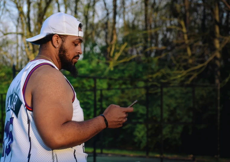 an image of man with cell phone playing tennis