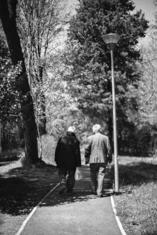 black and white pograph of two people walking