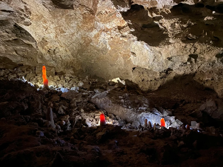 a group of people in a cave with some flags