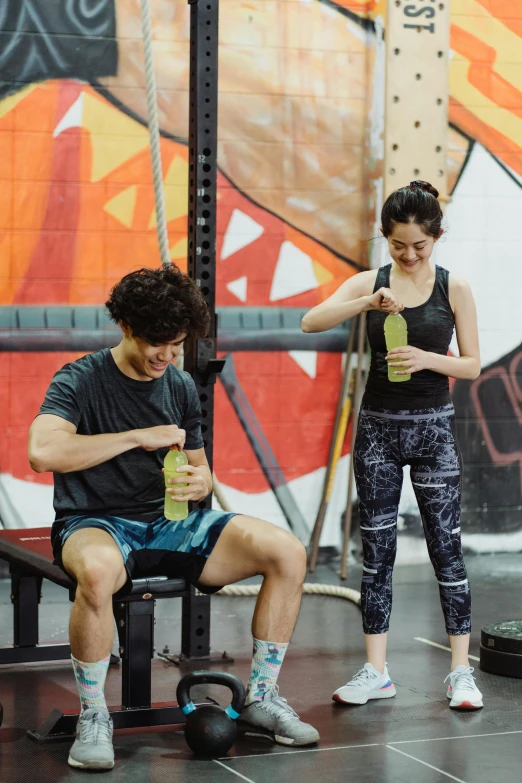 a woman is using her cell phone and talking with a man on a bench