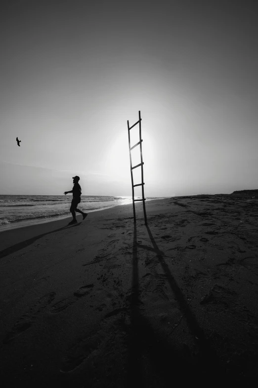 a ladder is placed in the sand near the ocean