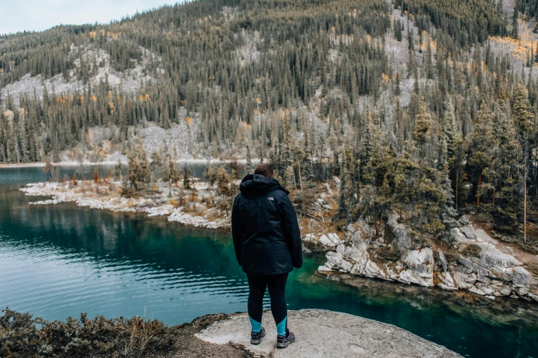 a person overlooking a lake in the mountains