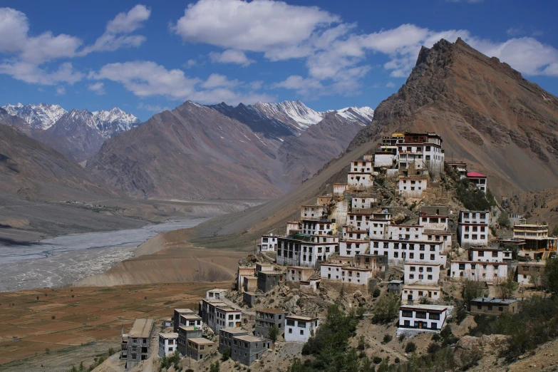 a cliff side city nestled between two mountains