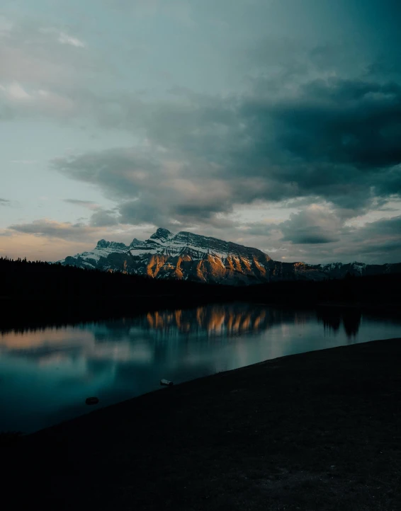 the mountain is reflecting in the water of a lake